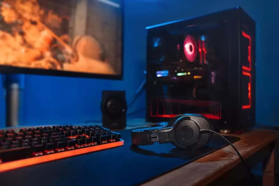 computer-gamer-workplace-with-new-game-keyboard-mouse-headphones-modern-pc-with-blur-blue-red-neon-light